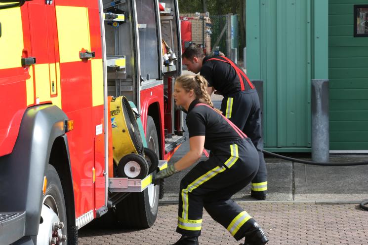 Female firefighter doing a fire exercise