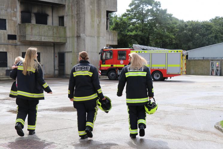 Three female firefighters walking